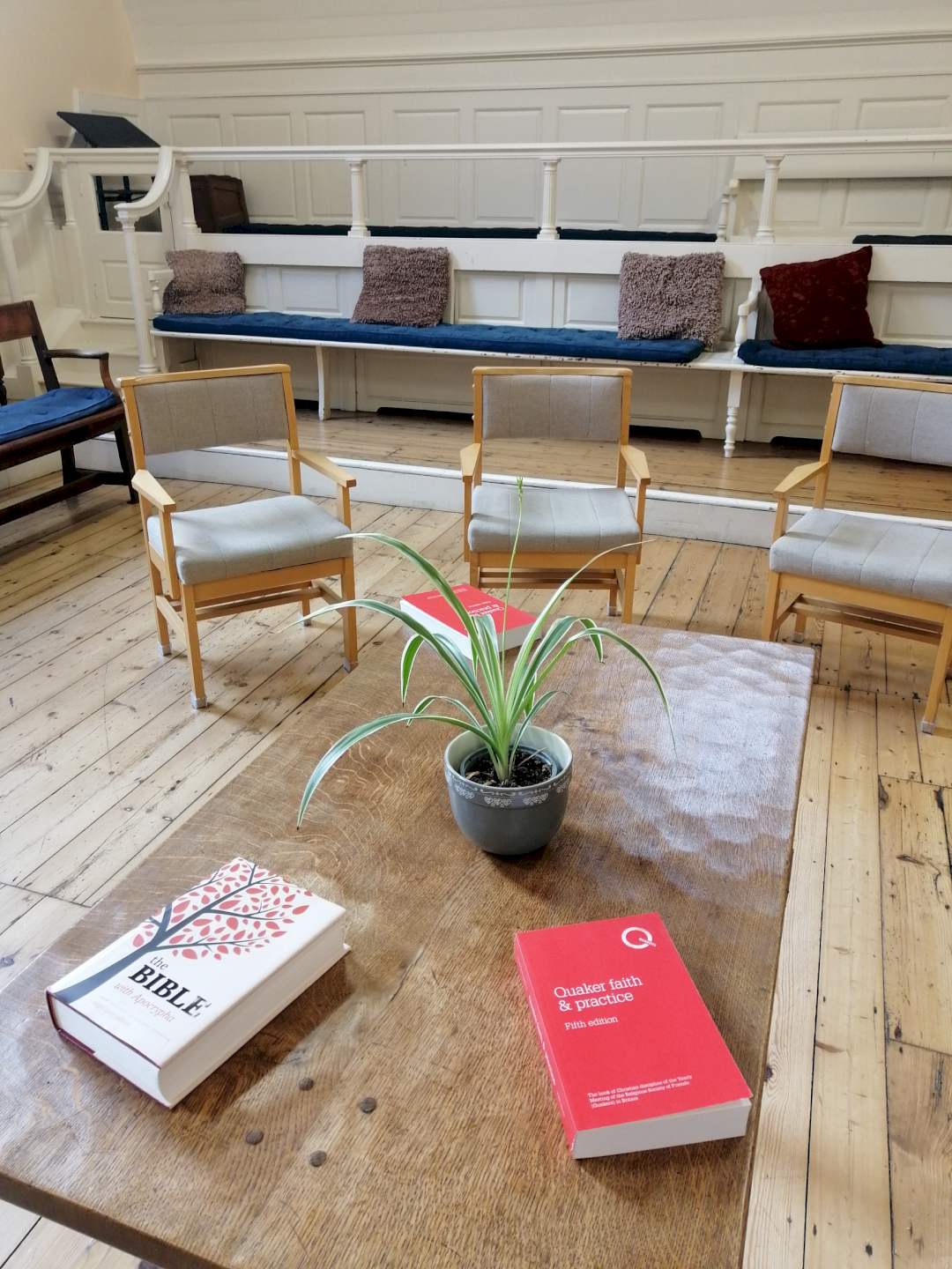 Close of of meeting room table with copies of Faith & Practice Close of of meeting room table with copies of Faith & Practice